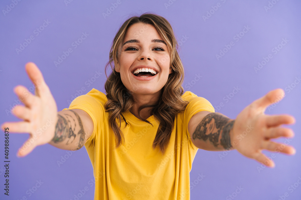 Happy beautiful girl laughing while reaching out her hands at camera Happy beautiful girl laughing while reaching out her hands at camera