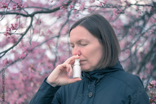 Εκτύπωση καμβά Woman using nasal spray outdoors
