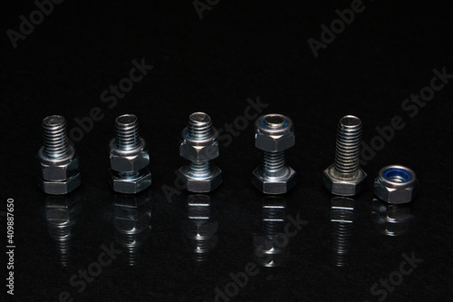 Bolts with nuts on 8mm on black background