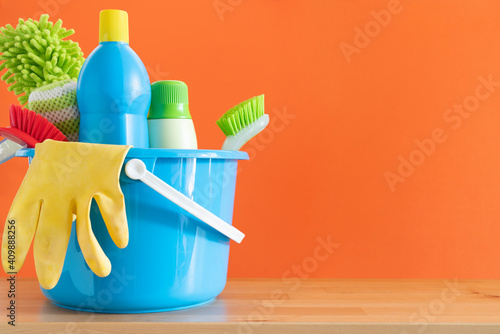 Canvas Print House cleaning product on wood table with orange background, home service or hou
