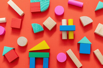 Wooden colorful blocks on red color background