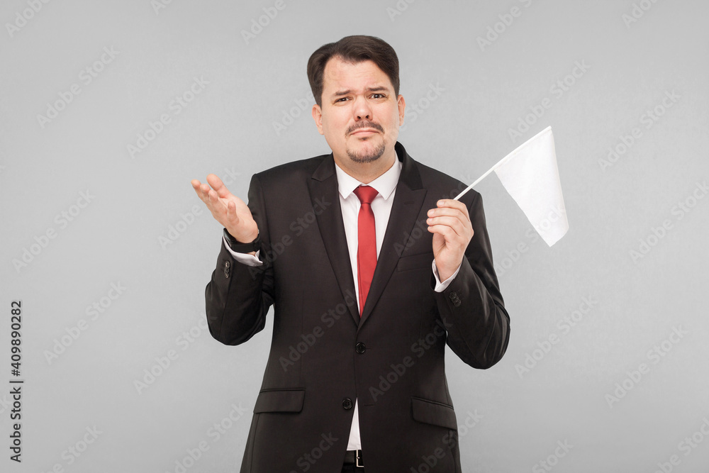 with flag and surrender. lost all money, business failed this failure. Indoor, studio shot, isolated on gray background with flag and surrender. lost all money, business failed this failure. Indoor, studio shot, isolated on gray background
