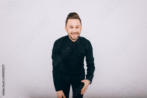 Happy young man dancing over white background