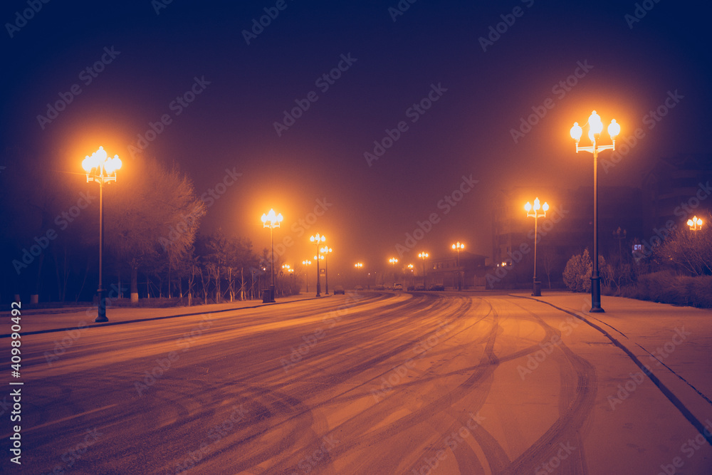 Street at night after snow in winter