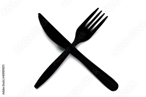 Black plastic cutlery knife fork spoon isolated on white background low highlight. For kitchen restaurant and table set up. concern to plastic conservative recycle items and one time use utensils