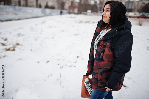 Yong asian woman wear jacket with handbag in cold winter day.