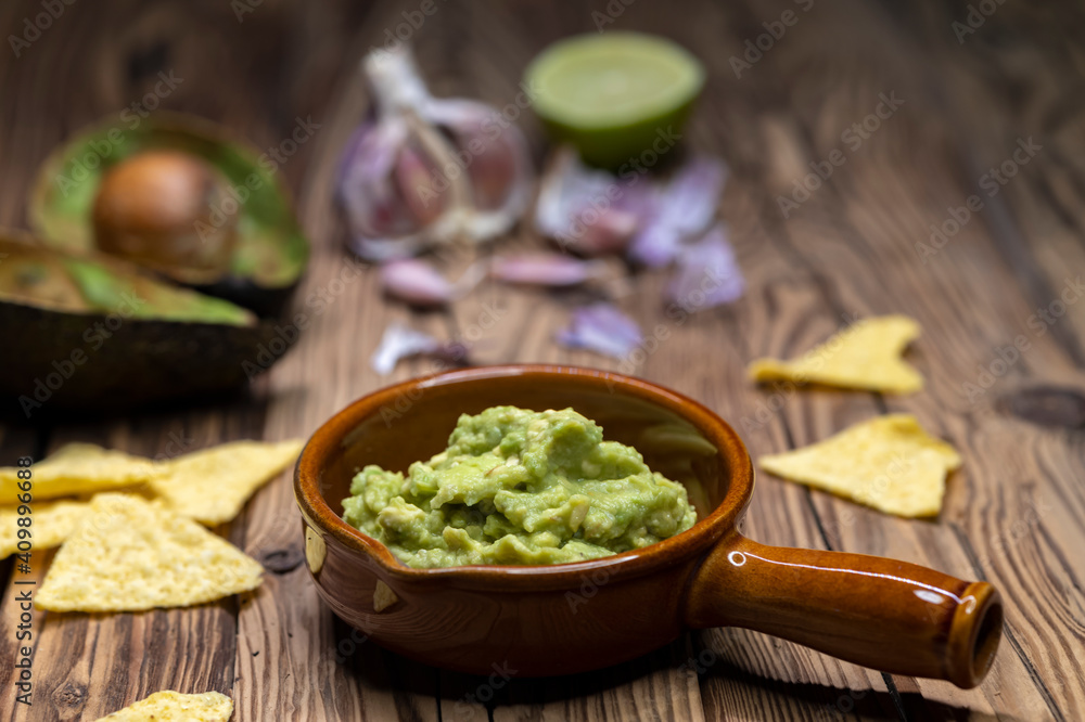 avocado dip flavored with garlic, chili, pepper, and lime juice with corn nachos avocado dip flavored with garlic, chili, pepper, and lime juice with corn nachos