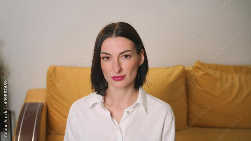Portrait of confident smiling young attractive businesswoman looking at camera successful beautiful at home office close up slow motion Portrait of confident smiling young attractive businesswoman looking at camera successful beautiful at home office close up slow motion