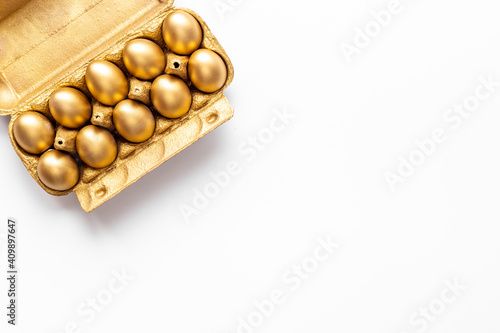 Golden Easter eggs in box cells. Save money. Symbol of wealth and good luck