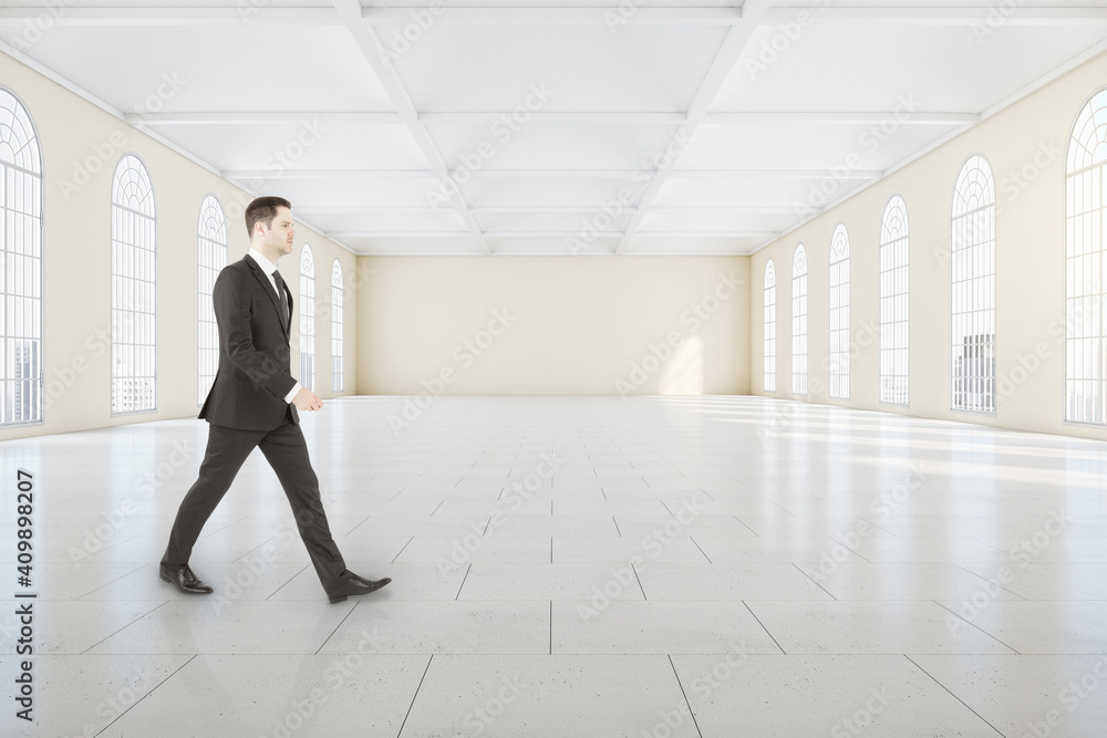 Businessman walking in classical gallery interior Businessman walking in classical gallery interior