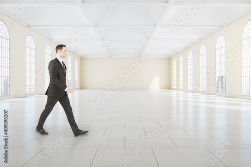 Businessman walking in classical gallery interior