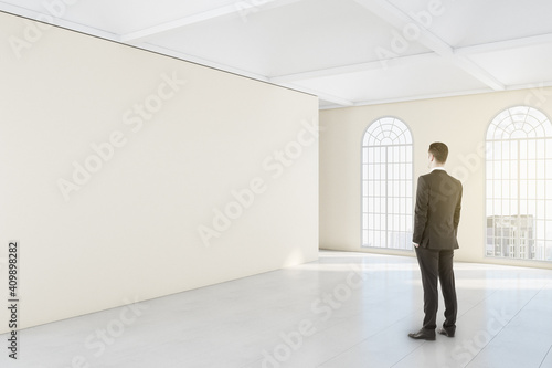 Businessman looking ion blank wall