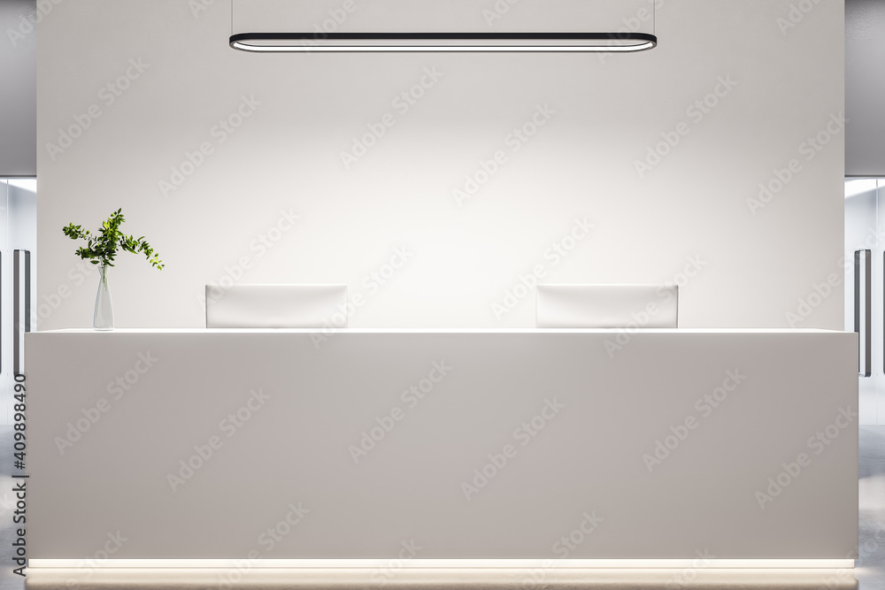 Obraz premium Modern office lobby with white reception desk, computers and blank wall.