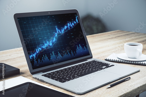 Laptop computer on office table with statistics on screen.