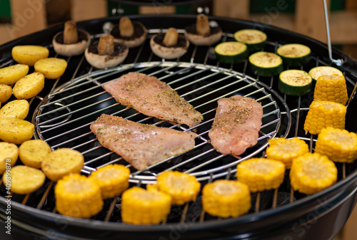 grill with potatoes, turkey meat, zucchini, mushrooms and sausages