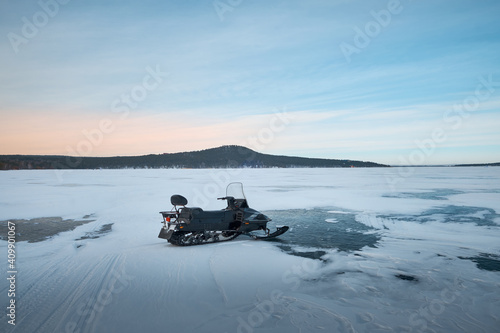 snowmobile on a frozen lake amid mountains