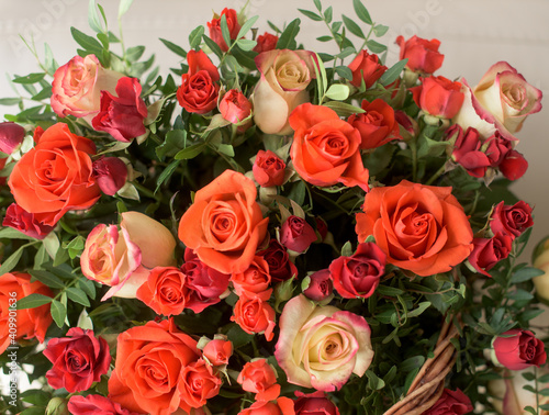 Bouquet of red  orange  yellow roses- a composition of multi-colored roses. Background for a postcard.