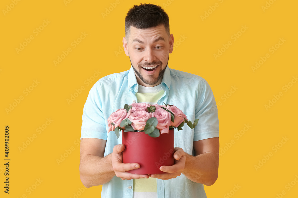 Surprised man with bouquet of beautiful flowers on color background Surprised man with bouquet of beautiful flowers on color background