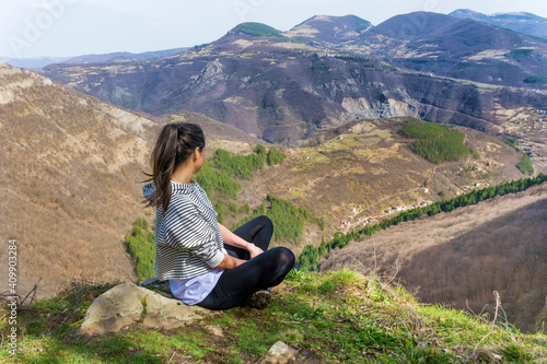 Young Woman Sitting above the Mountain with Stunning View .Pirin Mountain ,Bulgaria 