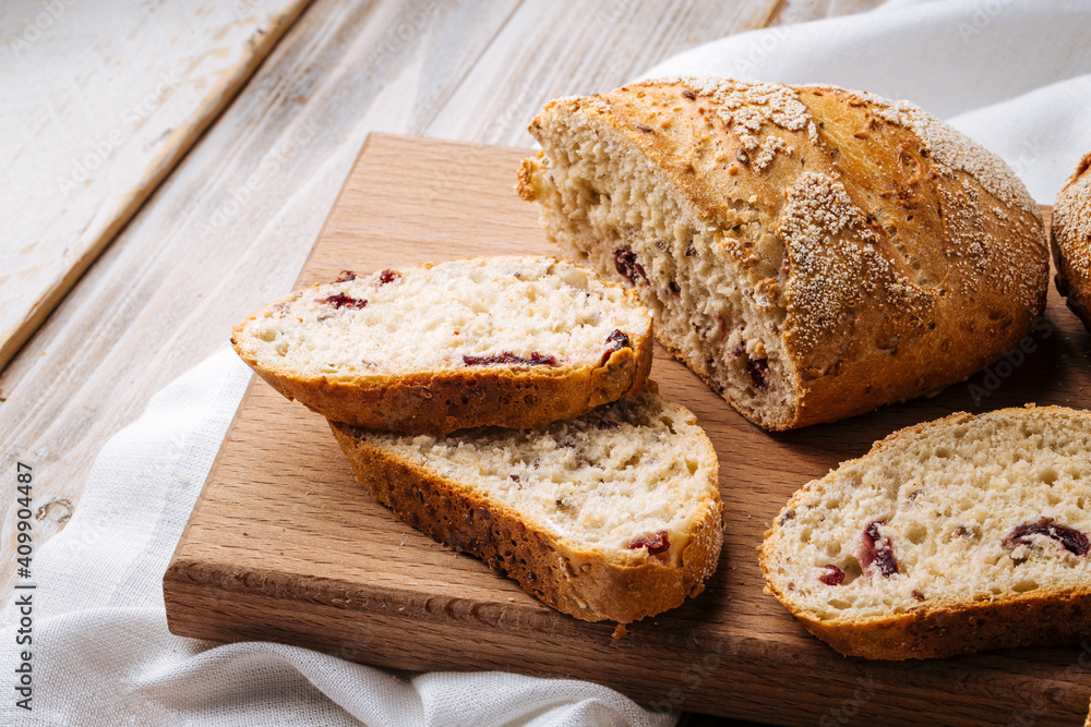Closeup on sliced muesli cereal bread on the wooden cutting board Closeup on sliced muesli cereal bread on the wooden cutting board