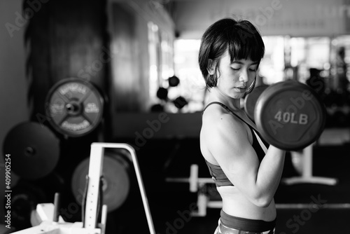 Young beautiful Asian woman working out at the gym