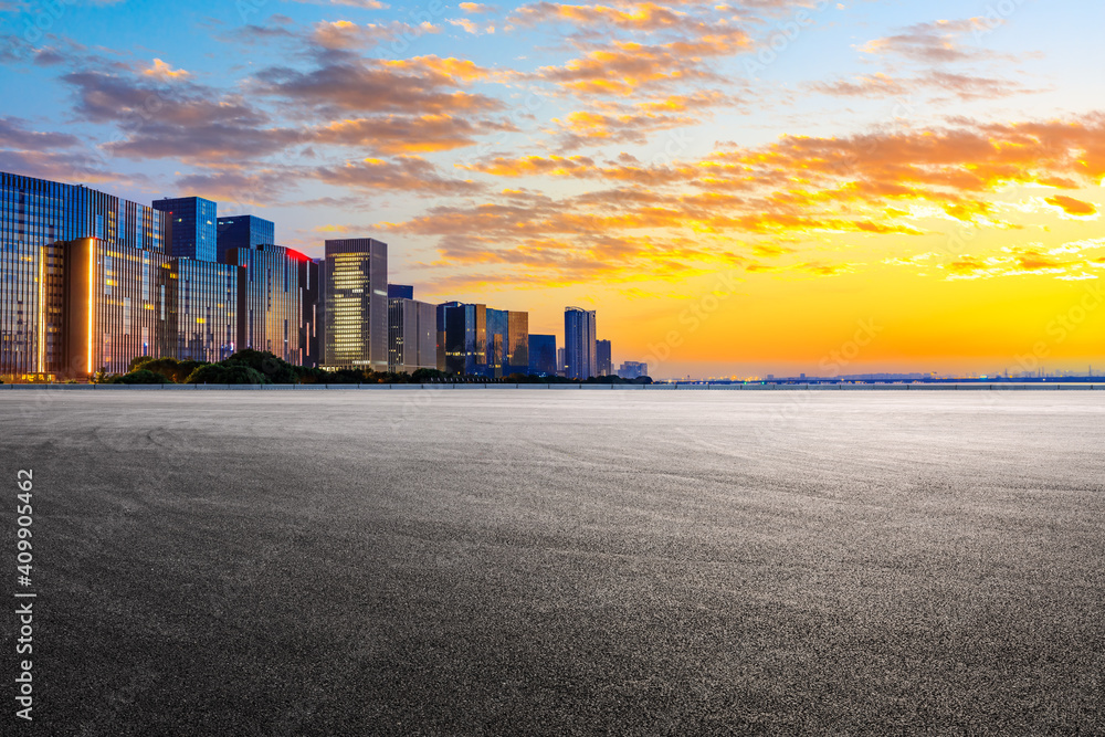 Race track road and Hangzhou skyline with buildings at sunrise. Race track road and Hangzhou skyline with buildings at sunrise.