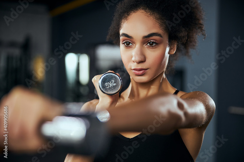 Portrait of pretty female doing sport in the gym