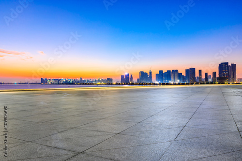 Empty square floor and modern city skyline in Hangzhou at sunrise,China.