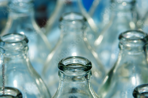 Close-up view of glass bottles stacked in crates.