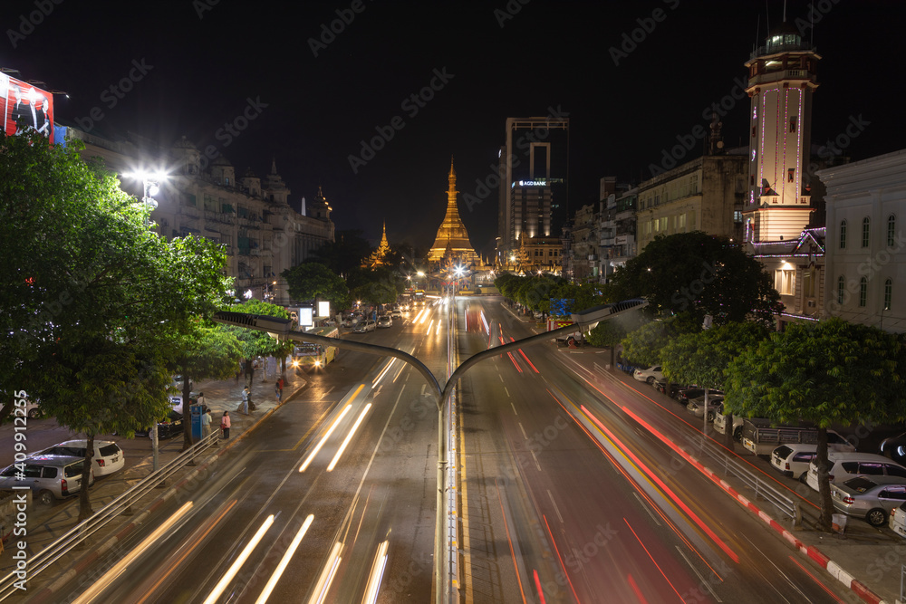 Detail of night traffic towards Sule Pagoda Buddhist temple and stupa, from the Sule Paya Road Pedestrian Bridge, in long exposure photography.