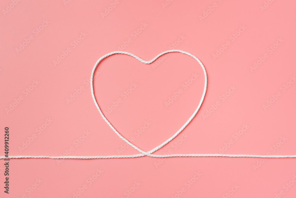 The rope made a heart shape on isolated pink background.
