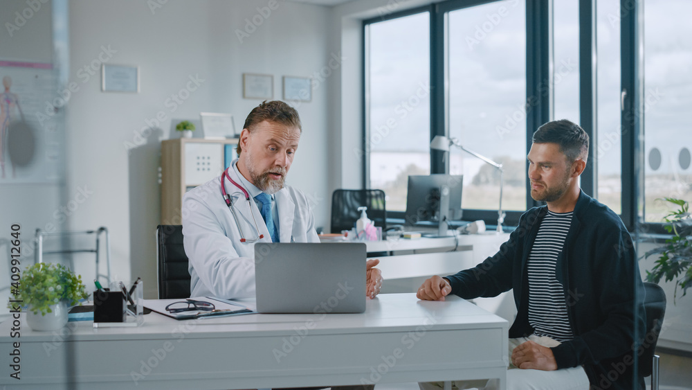 Family Doctor is Delivering Great News About Male Patient's Medical Results During Consultation in a Health Clinic. Physician in White Lab Coat Sitting Behind a Computer in Hospital Office. Family Doctor is Delivering Great News About Male Patient's Medical Results During Consultation in a Health Clinic. Physician in White Lab Coat Sitting Behind a Computer in Hospital Office.
