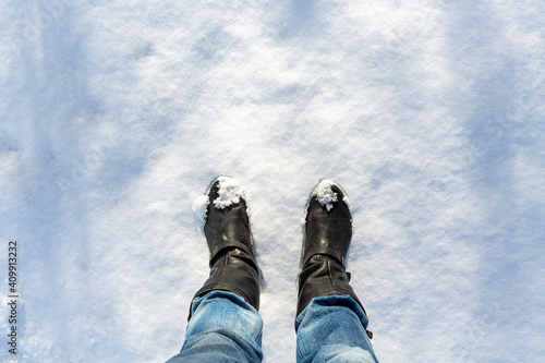 Person's legs on the snow seen from above
