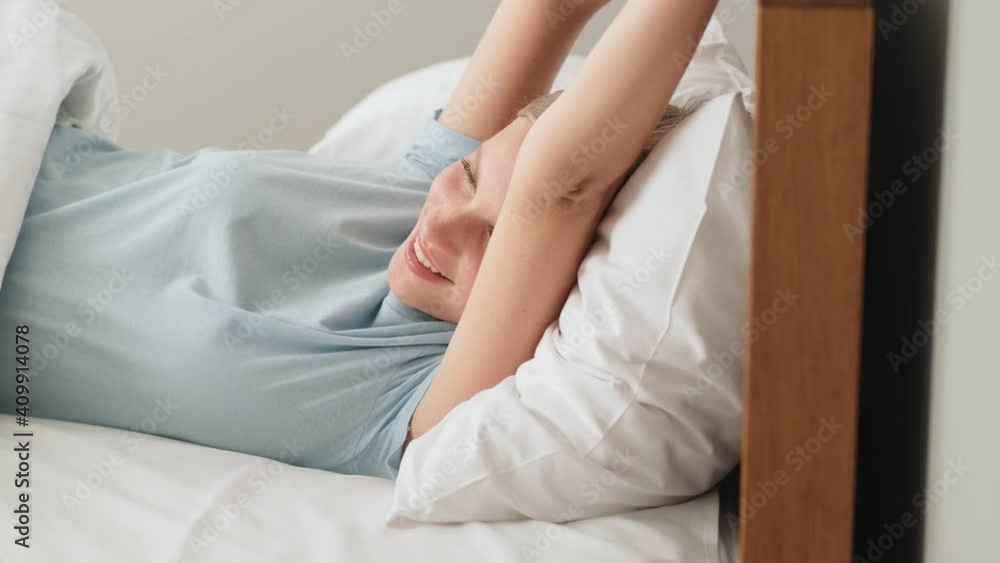 A smiling woman is getting up in the morning A smiling woman is getting up in the morning
