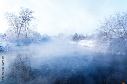 River in the fog. Forest by the river in hoarfrost, hoarfrost. Background water of the river and the forest on the shore in fog.