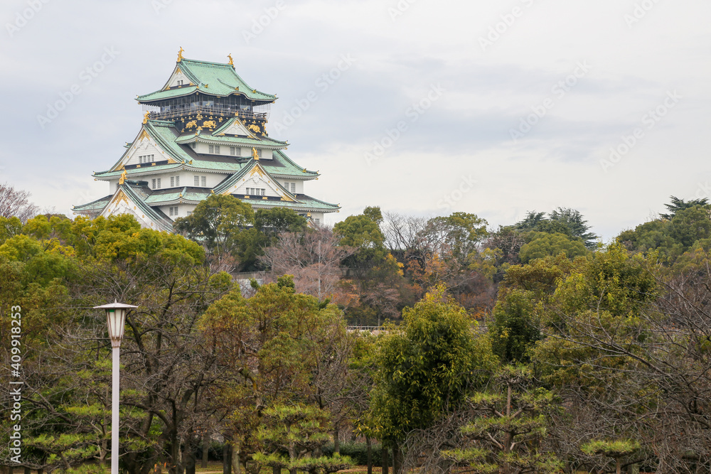 A low angle view looking towards the Osaka Castle below, around the city.