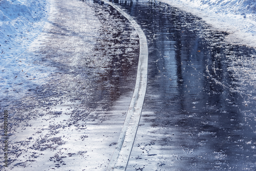 Wet asphalt road surface at winter morning.