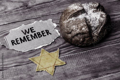 bread, star of david and the inscription we remember on a wooden table photo