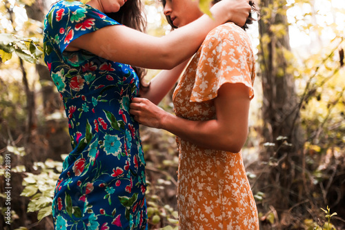 Fotografie Two young lesbians caressing each other in the woods