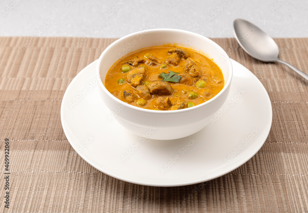 creamy peas and mushroom curry in a white bowl creamy peas and mushroom curry in a white bowl