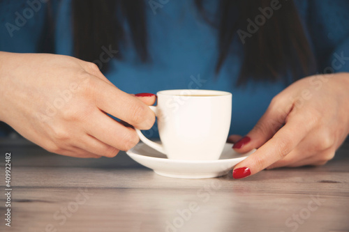  woman hand cup of coffee on the desk