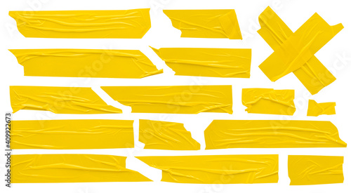 Yellow scotch, set of self-adhesive adhesive tape strips of various shapes and sizes on white background photo