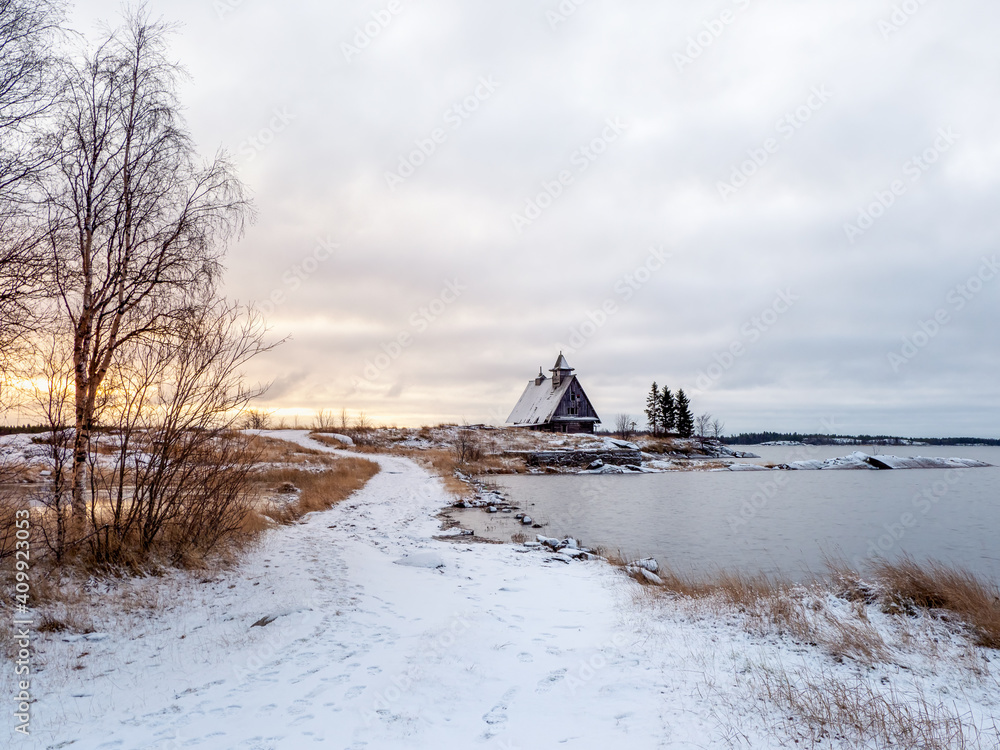 View of the island with a wooden old fishing lodge. The North of Russia, an authentic landscape. View of the island with a wooden old fishing lodge. The North of Russia, an authentic landscape.