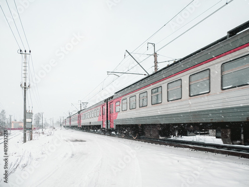 The train is in motion on a snowy winter day.