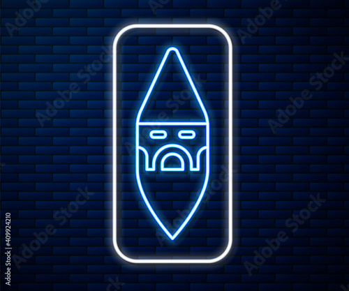 Glowing neon line Wizard warlock icon isolated on brick wall background. Vector.