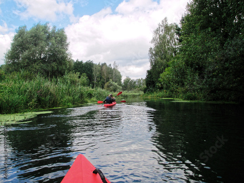 Fototapeta Naklejka Na Ścianę i Meble -  Kayaking Down the River. Water Sports and Summer Recreations Theme.