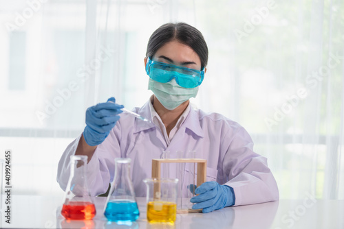 Asian women scientist with test tube making research in clinical laboratory, Science and chemistry concept, Medical technologist