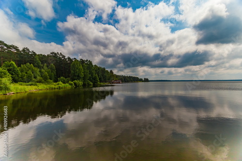 River banks against blue sky with white clouds in summer © Александр Коликов