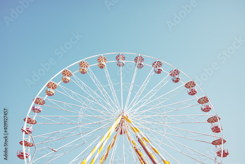 Picture of a Ferris wheel against the blue sky, retro colors toning applied. photo