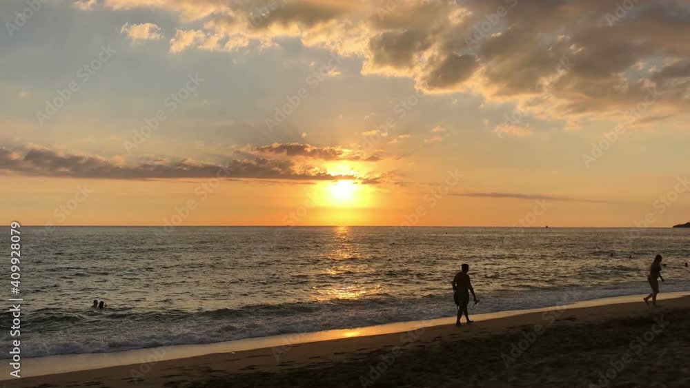 Timelapse of sandy sunset Kleopatra beach with silhouettes of people enjoying sea and sun. It is urban sandy beach is close to mountain with the Alanya castle, Turkey Timelapse of sandy sunset Kleopatra beach with silhouettes of people enjoying sea and sun. It is urban sandy beach is close to mountain with the Alanya castle, Turkey